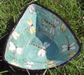 Green triangular clay plate with white dragonflies