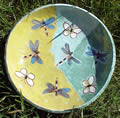 Green and yellow plate with dragonflies and butterflies